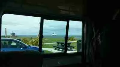 Ocean view through a campervan window: a serene perspective on coastal travel.
